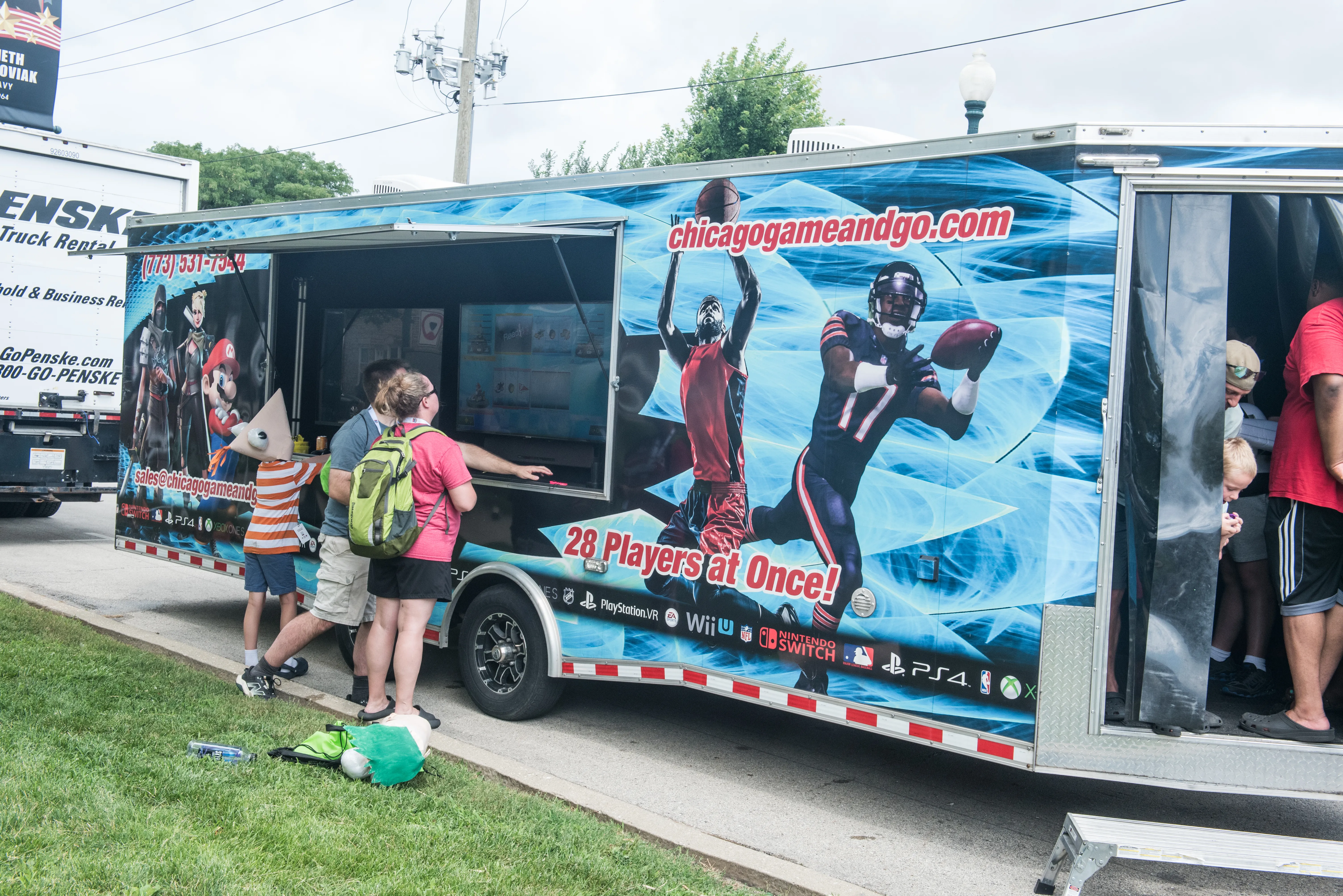 people playing outside of game and go truck