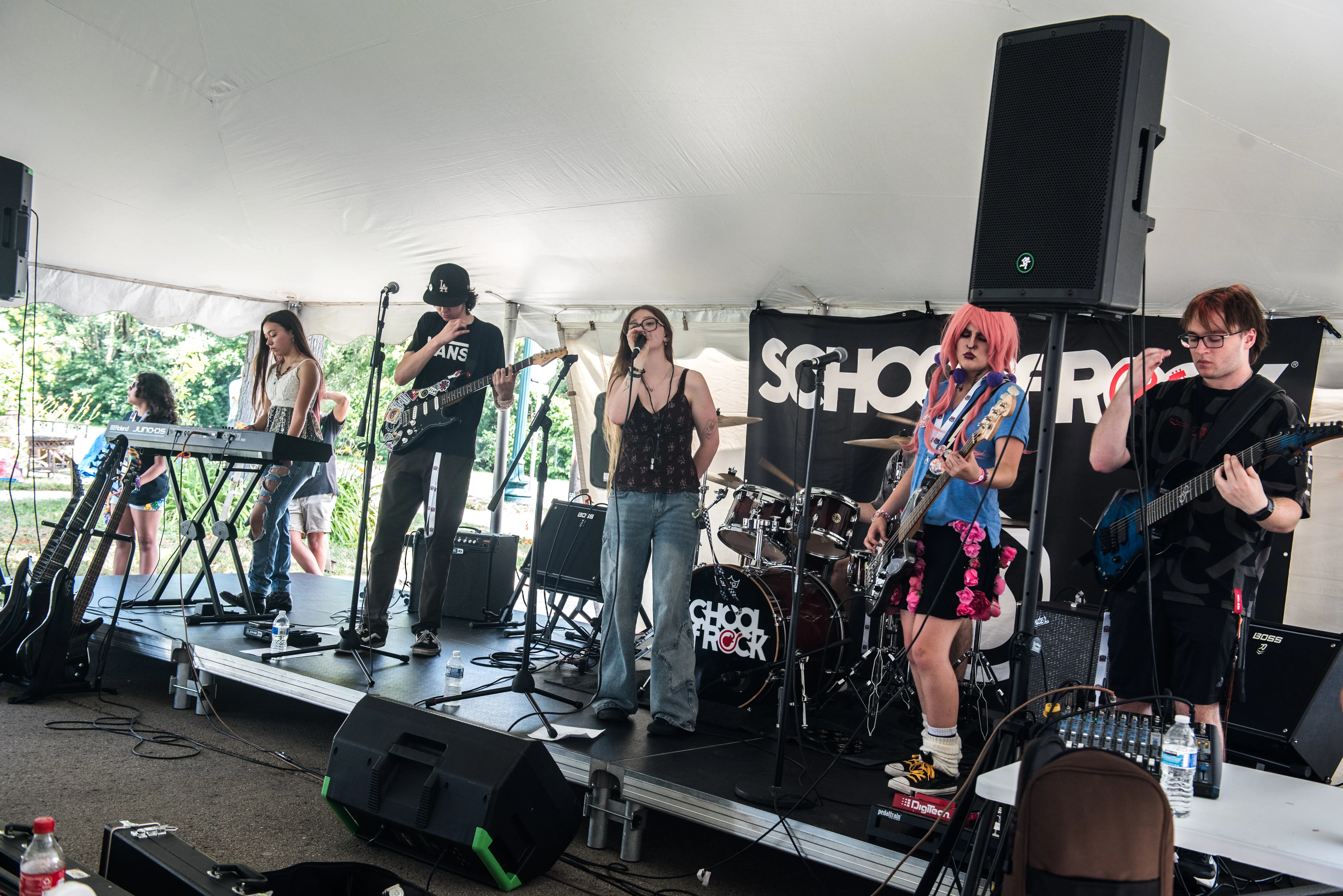 band on stage with 5 people