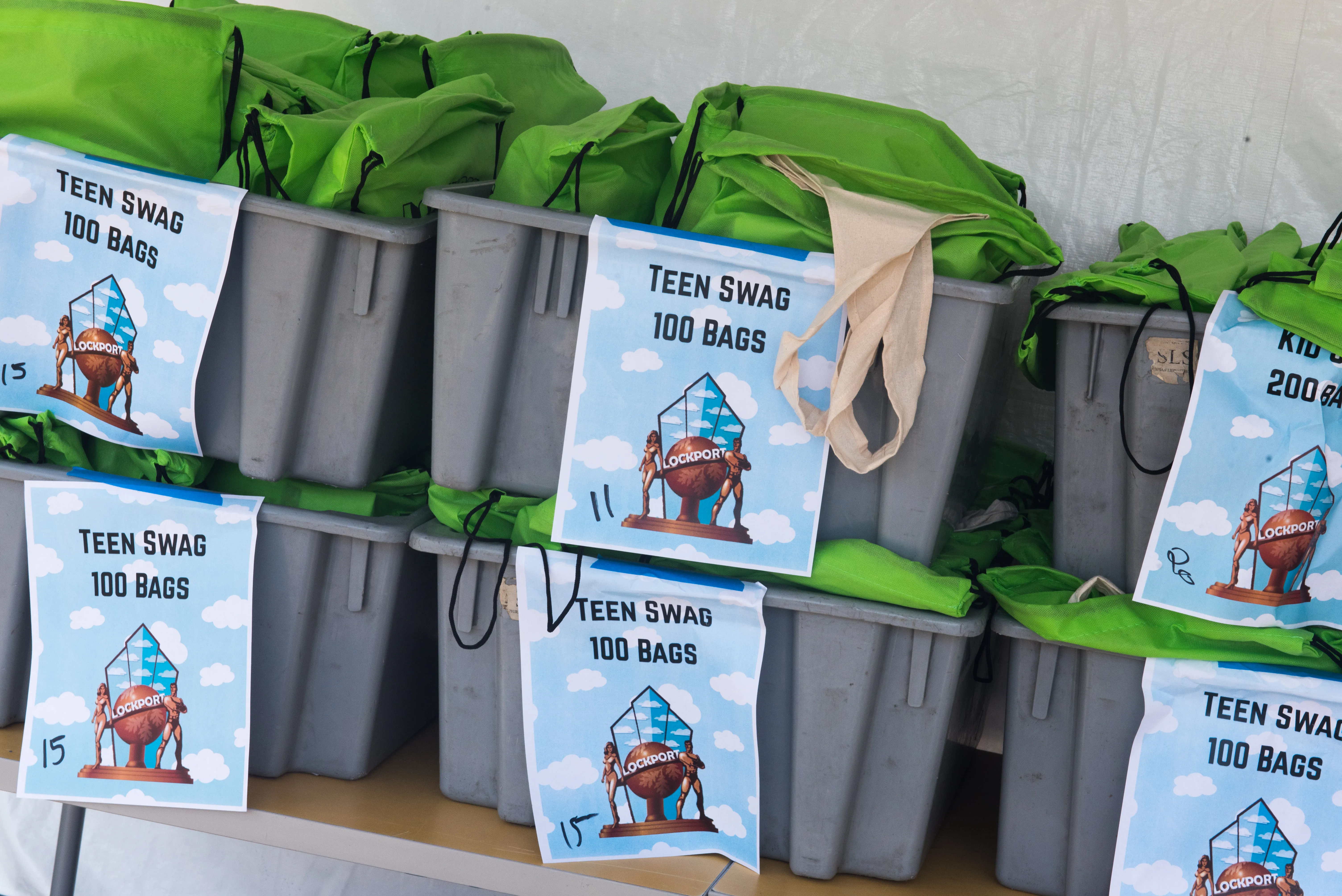 green swag bags in bins 